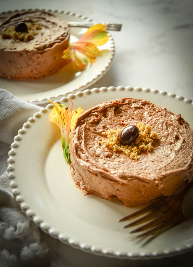 passover cake recipe for Ilse's Mocha Nut Sponge Cake on White plate with yellow flower