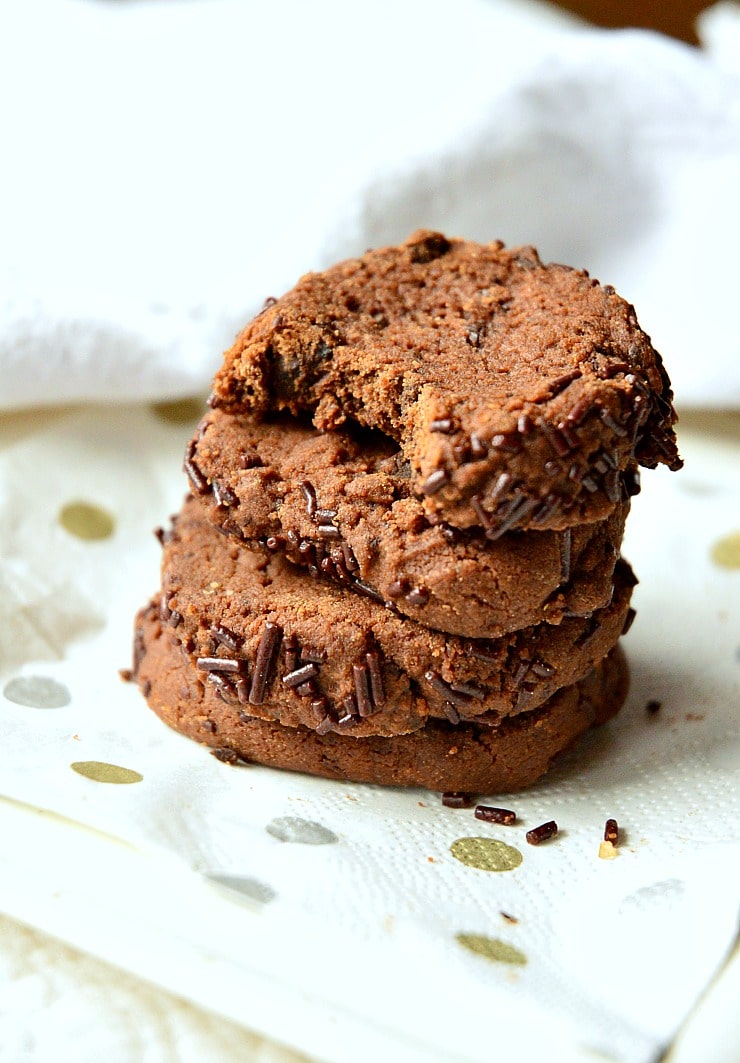 Stack of World Peace Cookies on gold dotted napkin.