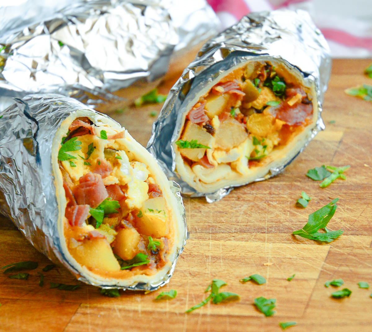 Breakfast Burritos in foil on cuttin board