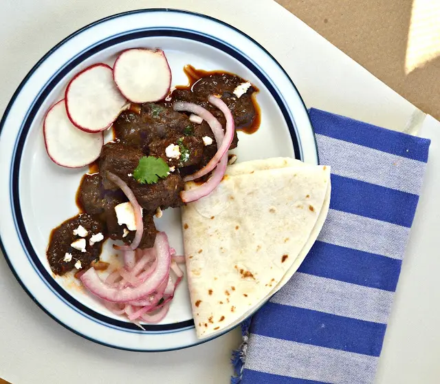 Carne Asada is perfect for tacos or just served with rice. It is cooked with a rich chili sauce and turns into a magical dish! #mexicanfood #carneasada #pork #tacos www.thisishowicook.com