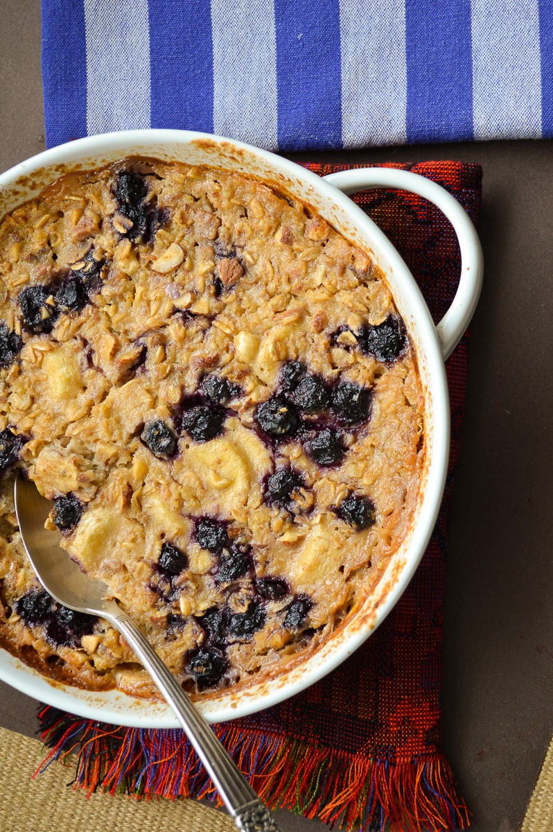 Baked blueberry oatmeal in white dis/blue napkin