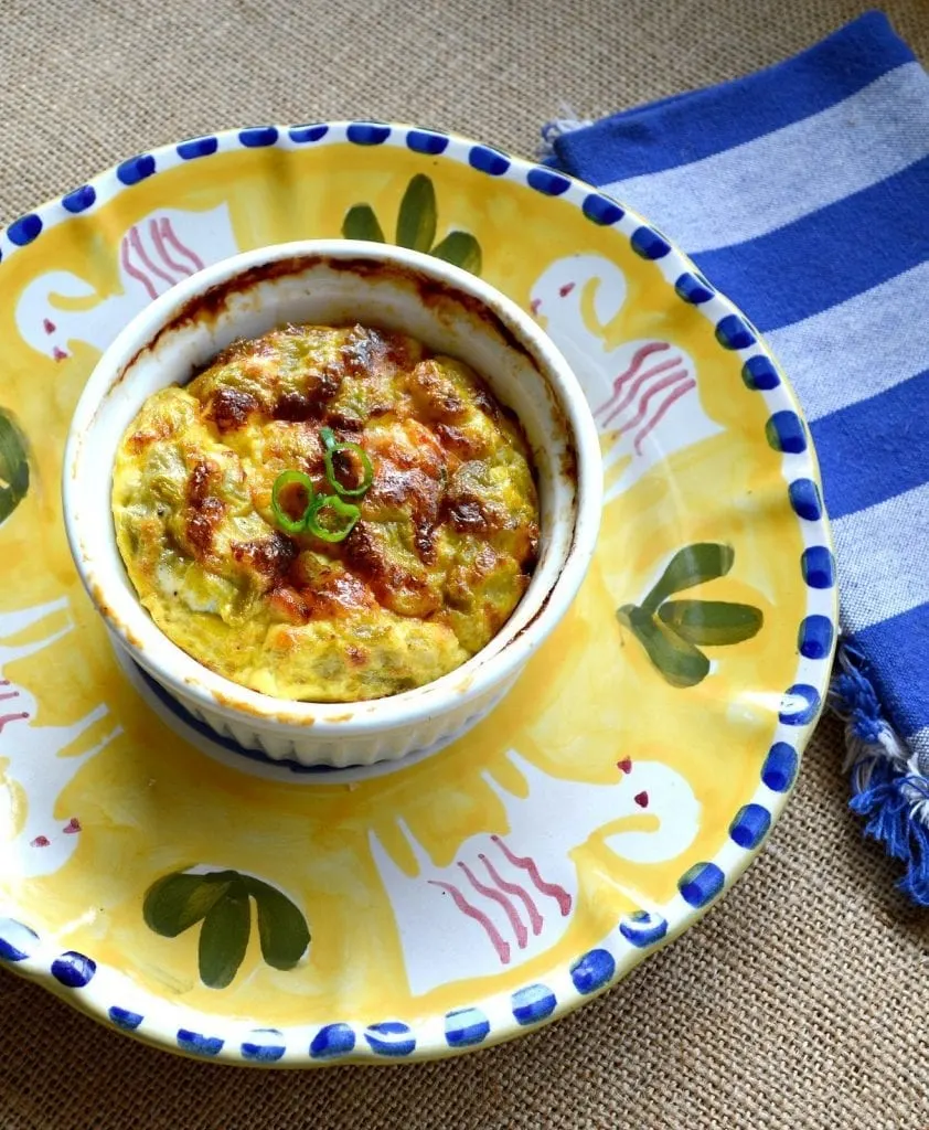 The fast and delicious egg souffle is made by layering your favorite ingredients and then pouring a combo of milk and beaten eggs over the top. It rises quite nicely and only takes 10 minutes to throw together. Perfect for brunch and makes everyone feel so special! #brunch #souffle #eggs #breakfast www.thisishowicook.com