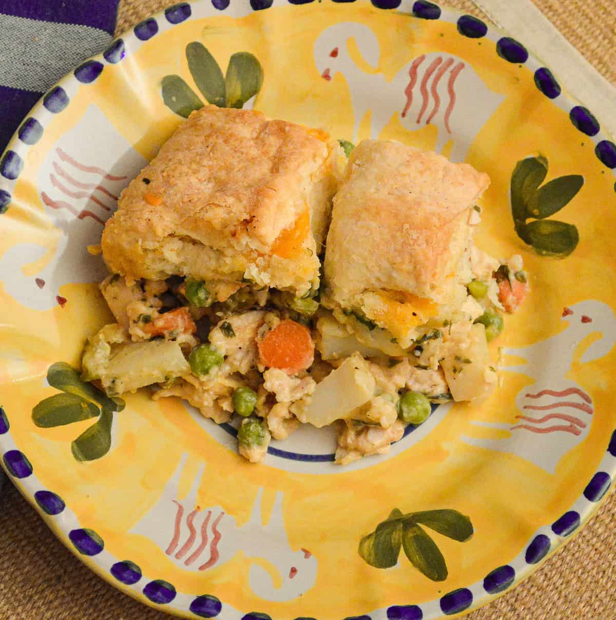 chicken pot pie with biscuits served on plate