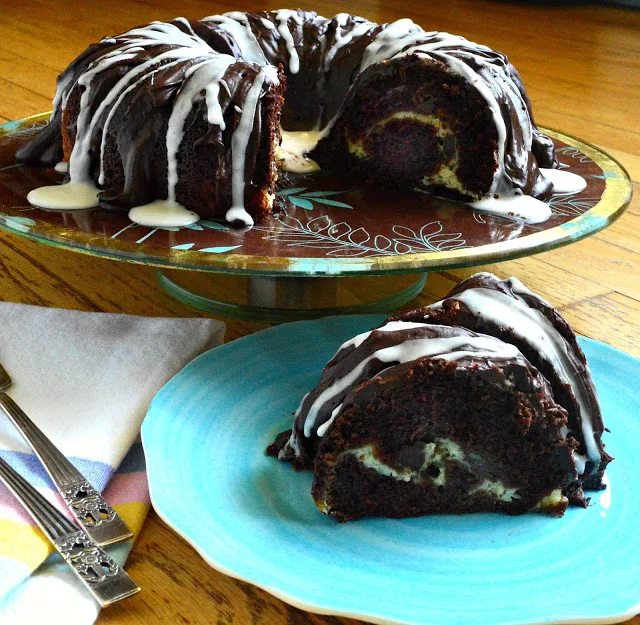 This moist and decadent chocolate bundt cake filled with cream cheese and chocolate chips is made in a flash. This is so good it has withstood the test of time! #chocolatecake #cupcakes #bundtcake #desserts #baking www.thisishowicook.com