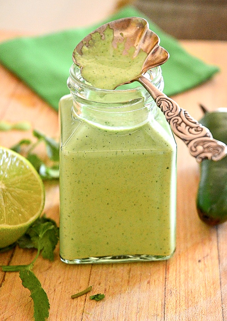 Peruvian Green Sauce in jar with spoon