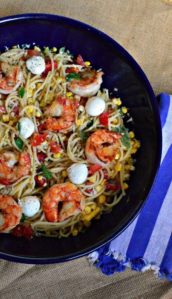 Lemon Shrimp and a lemon vinaigrette over pasta with grilled corn and tomatoes and cheese is such a great summer dish. Perfect hot or at room temperature, my kids love this! #shrimp #pasta #dinner www.thisishowicook.com 