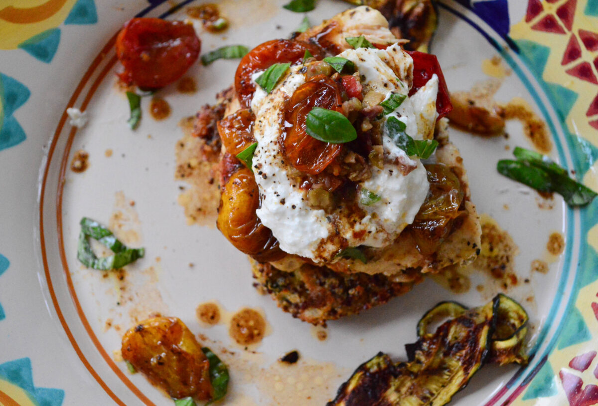 quinoa cakes with chicken caprese on colorful plate