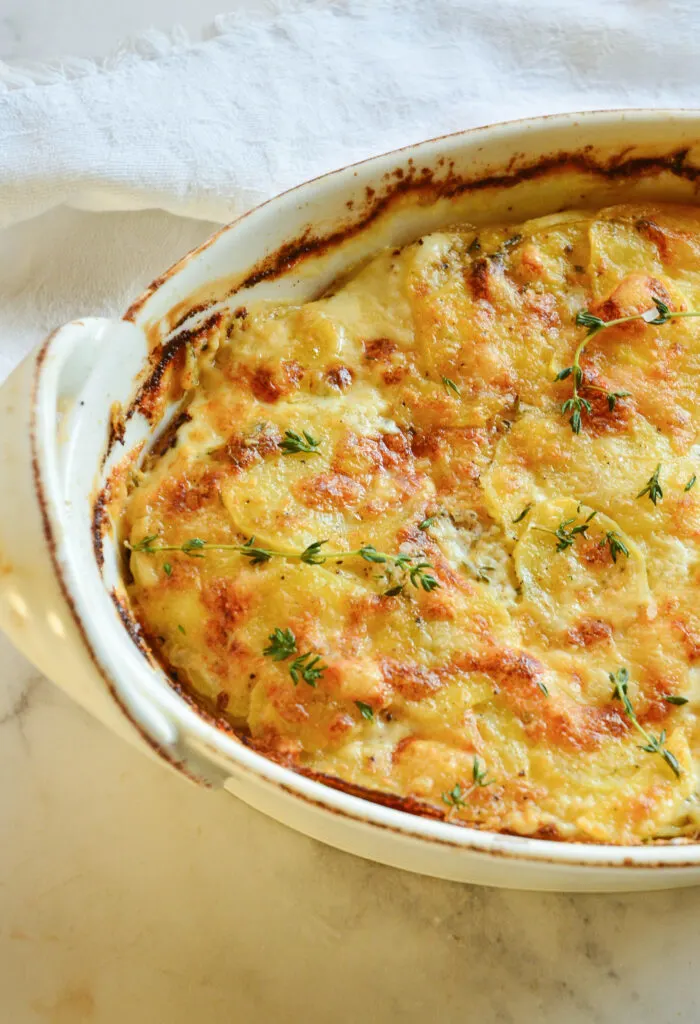 Scalloped potatoes in oval dish