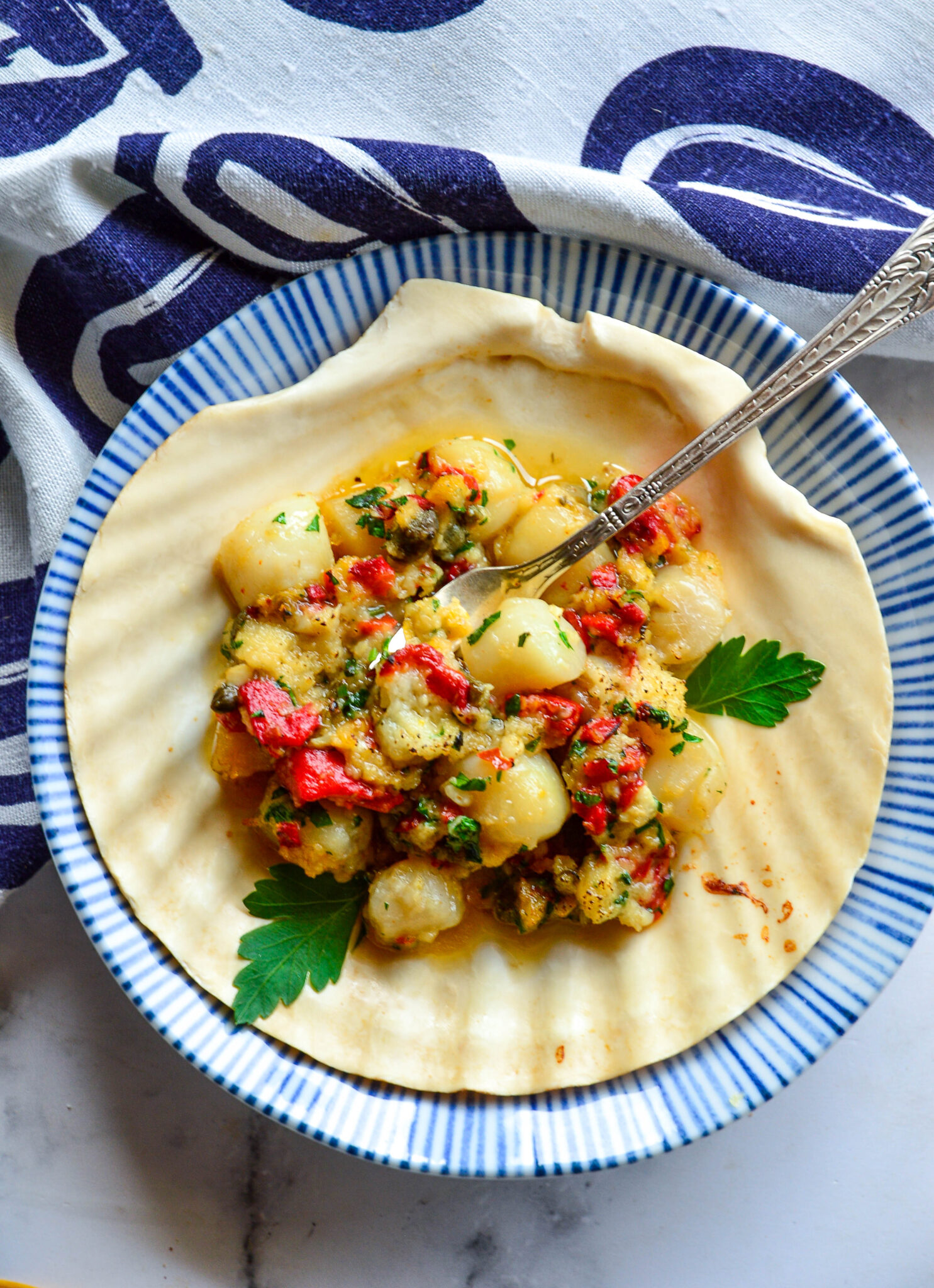 These scallops are super fast and super easy to make. Lots of lemon and garlic and capers. Oh my! www.thisishowicook.com #scalloprecipes #seafood bay scallop recipe in scallop shell