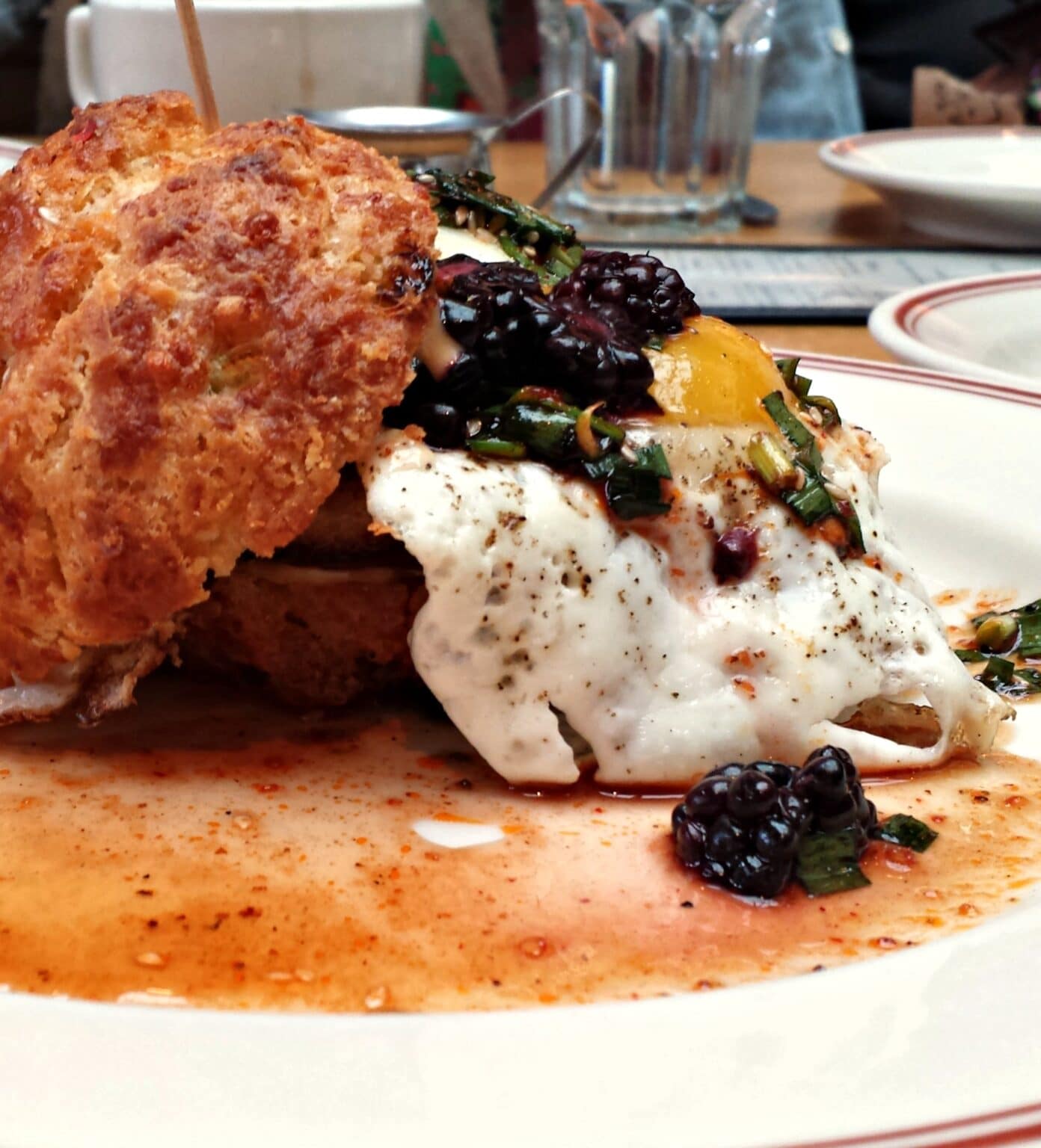 Sandwich with blackberries and fried egg