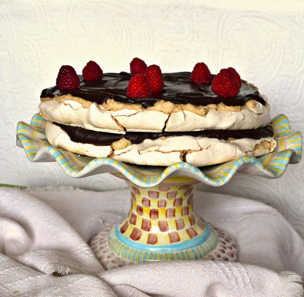 This Raspberry Meringue Cake with chocolate ganache is as simple as it gets. Really. And it's a showstopper and oh so delicious. Perfect for Passover or Easter or anytime you need an impressive dessert. #meringue #cake #Chocolate #dessert www.thisishowicook.com Raspberry Meringue Cake with chocolate ganache