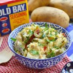 Old Bay can/blue bowl of potato salad/potatoes
