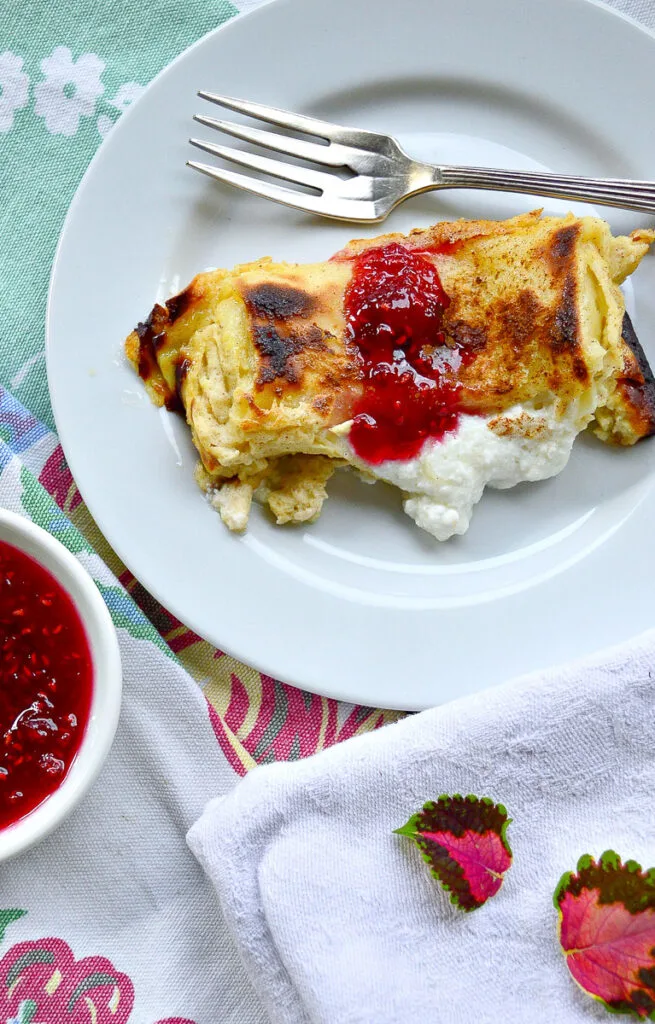 cheese blintz casserole recipe with blintz on plate with jam