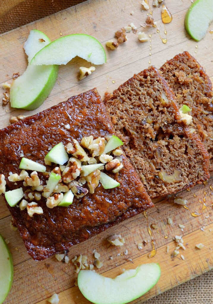 honey cake recipe with sliced apples on wood cutting board