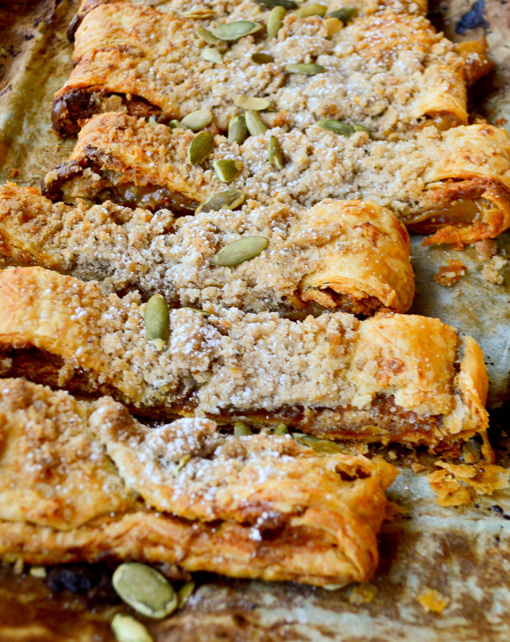 strips of pumpkin puff pastry kringle on baking sheet