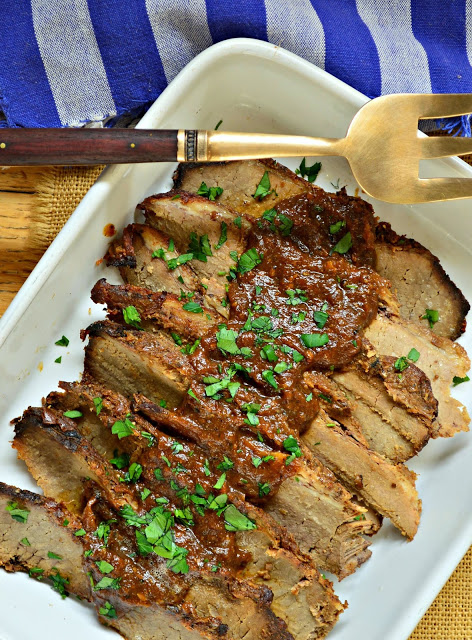 best Jewish Brisket in white pan with decorative fork