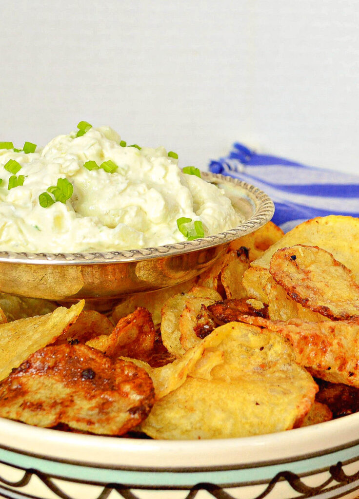 cream cheese onion dip in bowl with potato chips