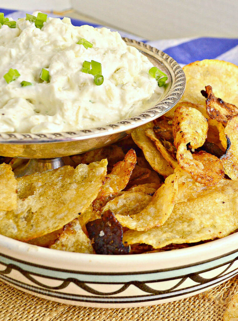 cream cheese onion dip in bowl with potato chips