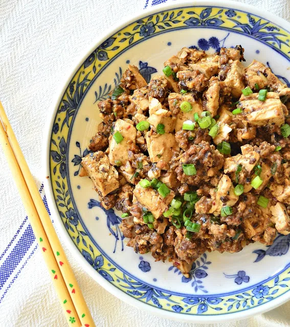 Ma Po Tofu is pure Chinese comfort food. Flavored with a bit of ground pork and garlic, and a bit of Szechuan peppercorns, the soft tofu contrasts well with the heat. I love it when it is made right! #tofu #Chinesefood #Szechuan www.thisishowicook.com