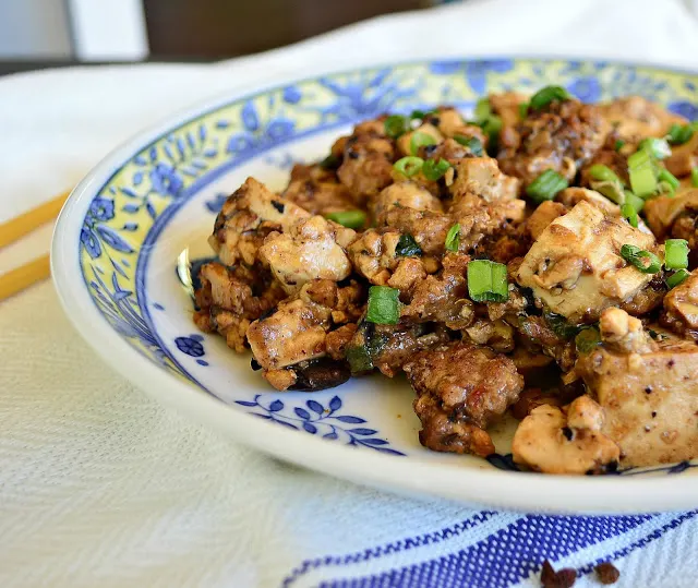 Ma Po Tofu is pure Chinese comfort food. Flavored with a bit of ground pork and garlic, and a bit of Szechuan peppercorns, the soft tofu contrasts well with the heat. I love it when it is made right! #tofu #Chinesefood #Szechuan www.thisishowicook.com