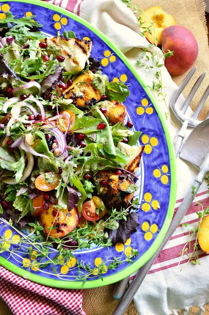 grilled peach and halloumi salad on blue and yellow decorative platter