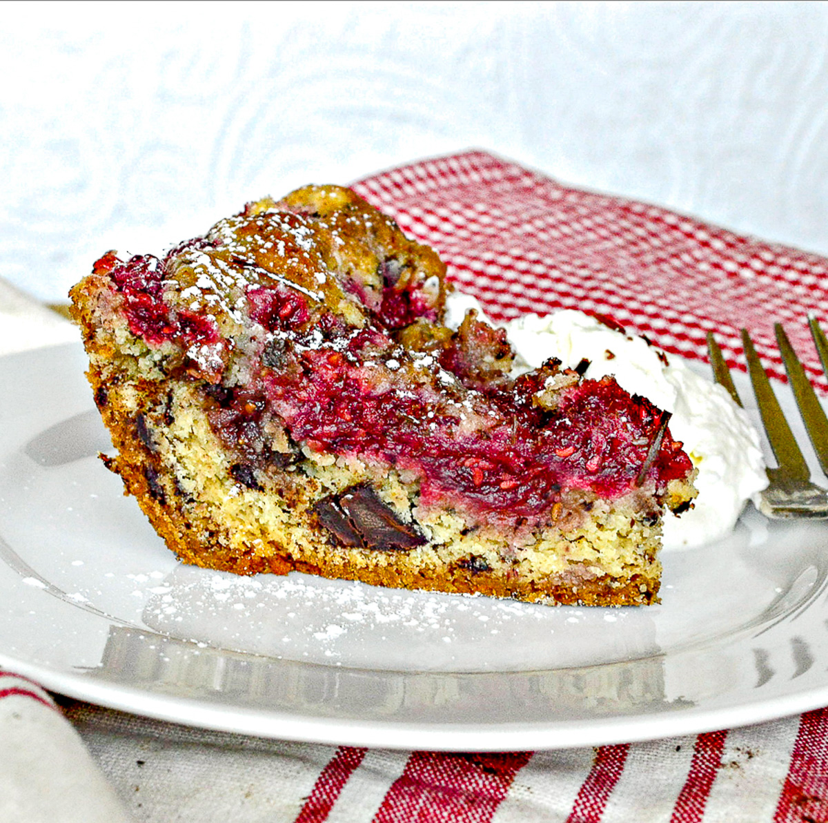 Summer Berrry Cake Slice with chocolate chips/white plate