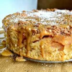 passover apple cake with streusel and caramel sauce on glass platter