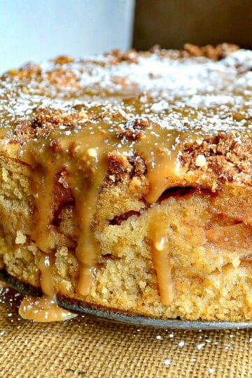 passover apple cake with streusel and caramel sauce on glass platter