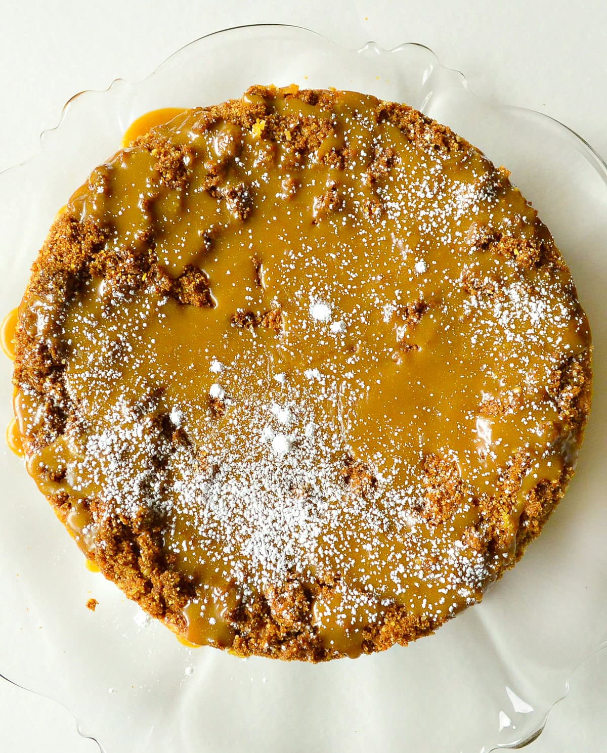 passover apple cake with caramel sauce on glass platter