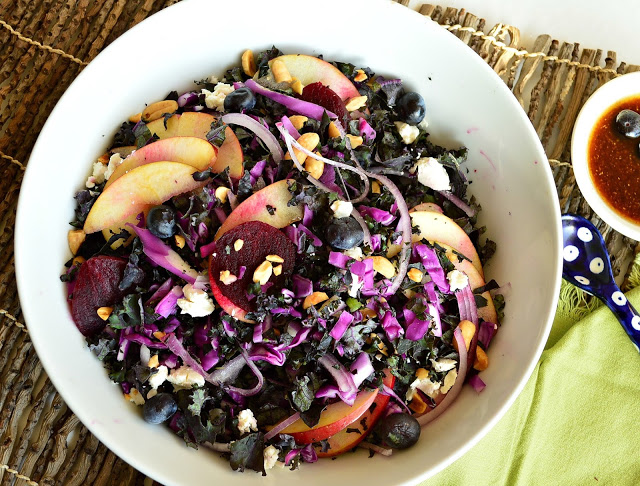 This purple kale salad with blueberries, apples, beets, peanuts and goat's cheese also has the most wonderful blueberry vinaigrette. Add some color to you life with this awesome salad! www.thisishowicook.com #salad #kale #blueberries