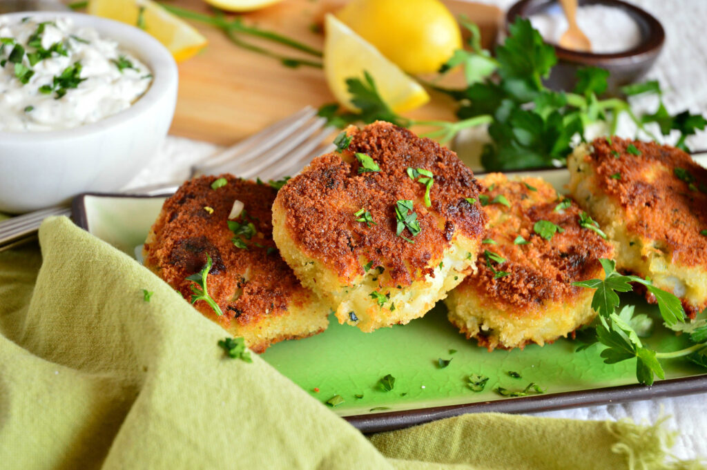 Irish Cod Fish Cakes Recipe on green plate with tartar sauce and lemon