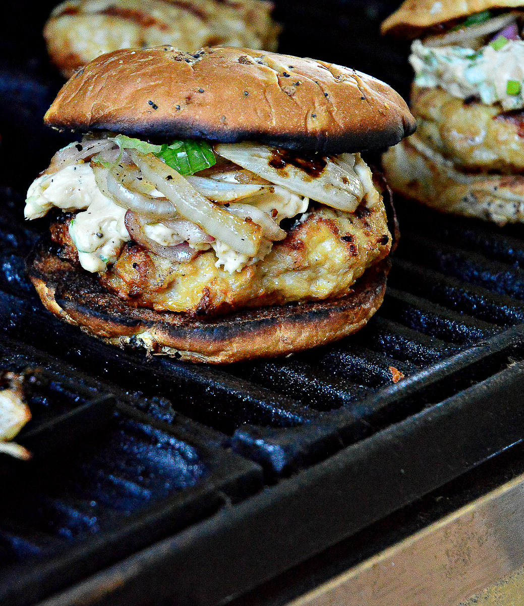 Chicken Burger with Onions on grill