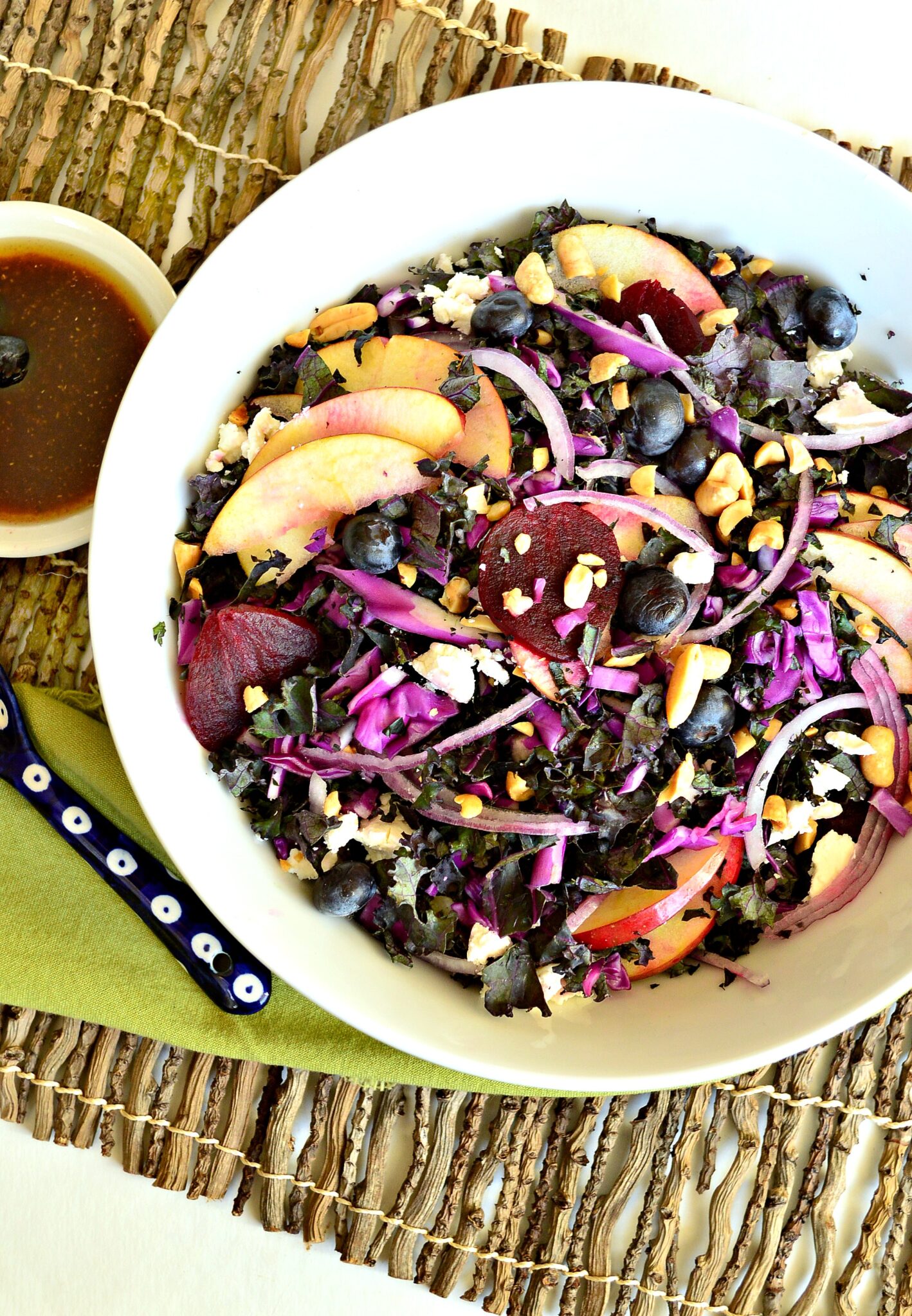 purple kale salad in white bowl