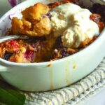 Cornbread Bread Pudding with Blueberries in white dessert dishes