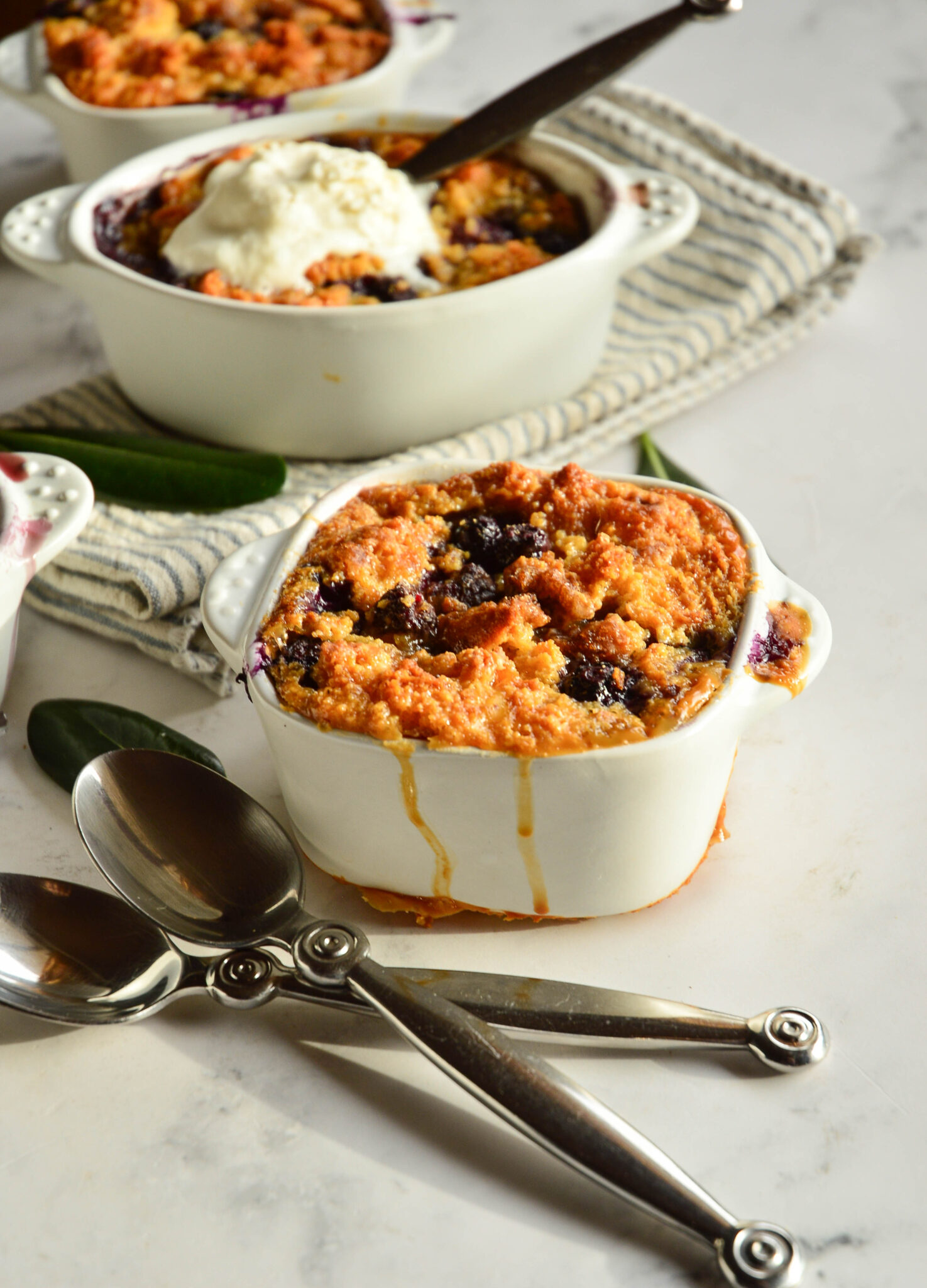 trio pf individual cornbread bread pudding in small white baking dishes