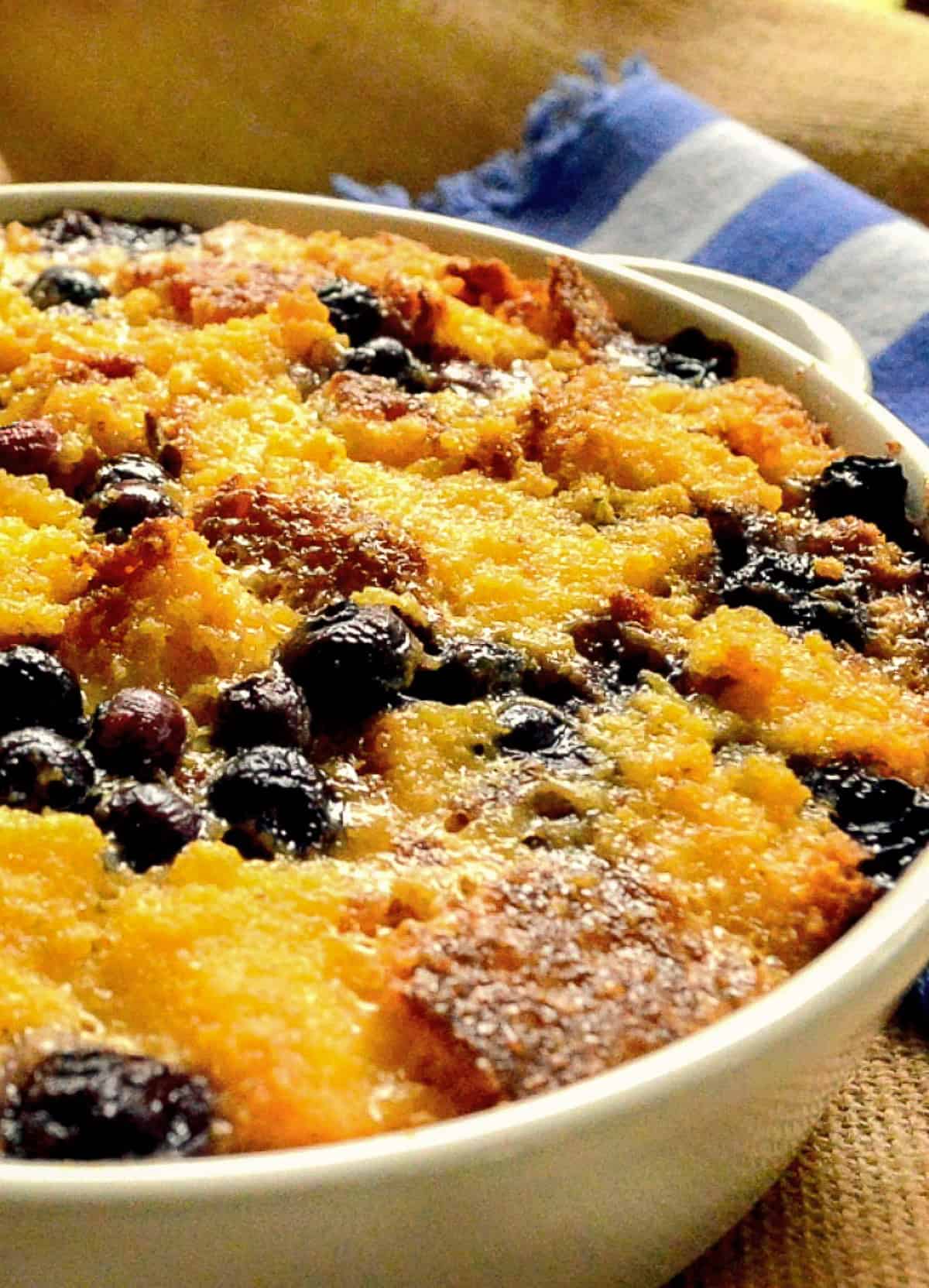 close up of leftover cornbread bread pudding with blueberries
