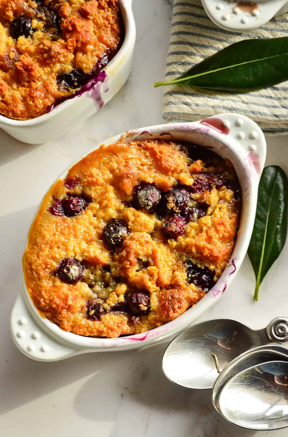 cornbread bread pudding with blueberries in individual ramekins