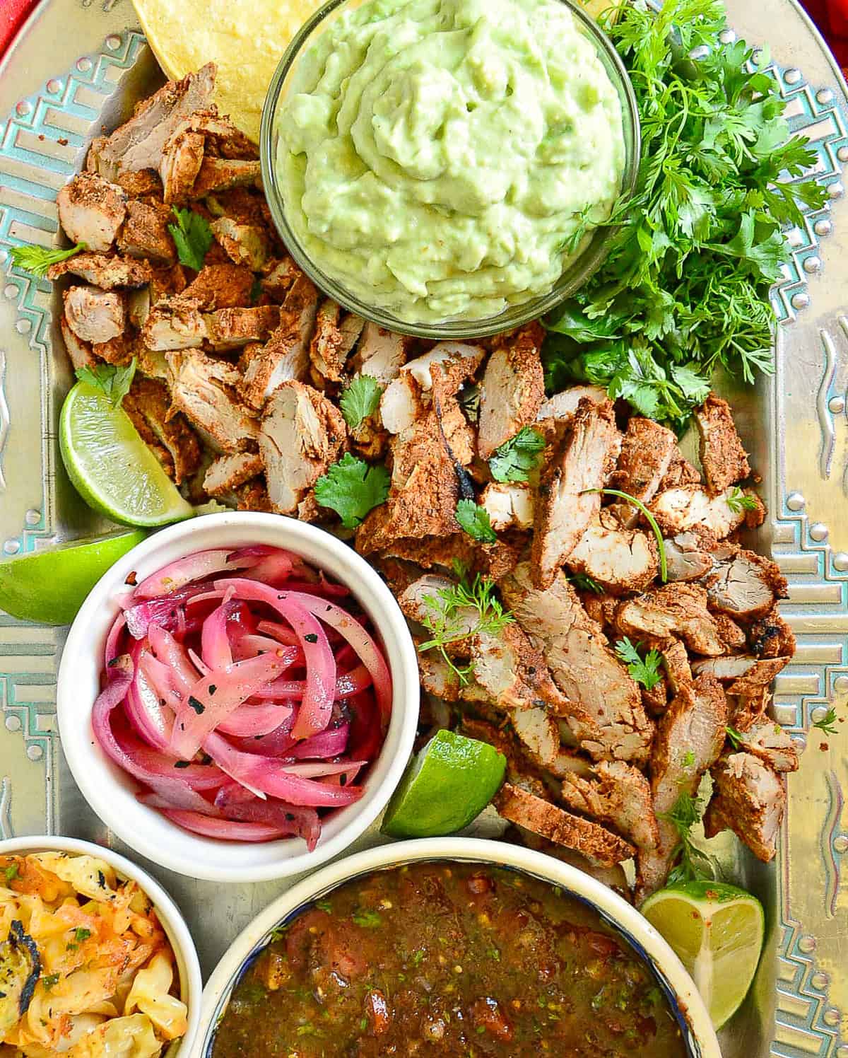 mexican pork tenderloin on platter with toppings