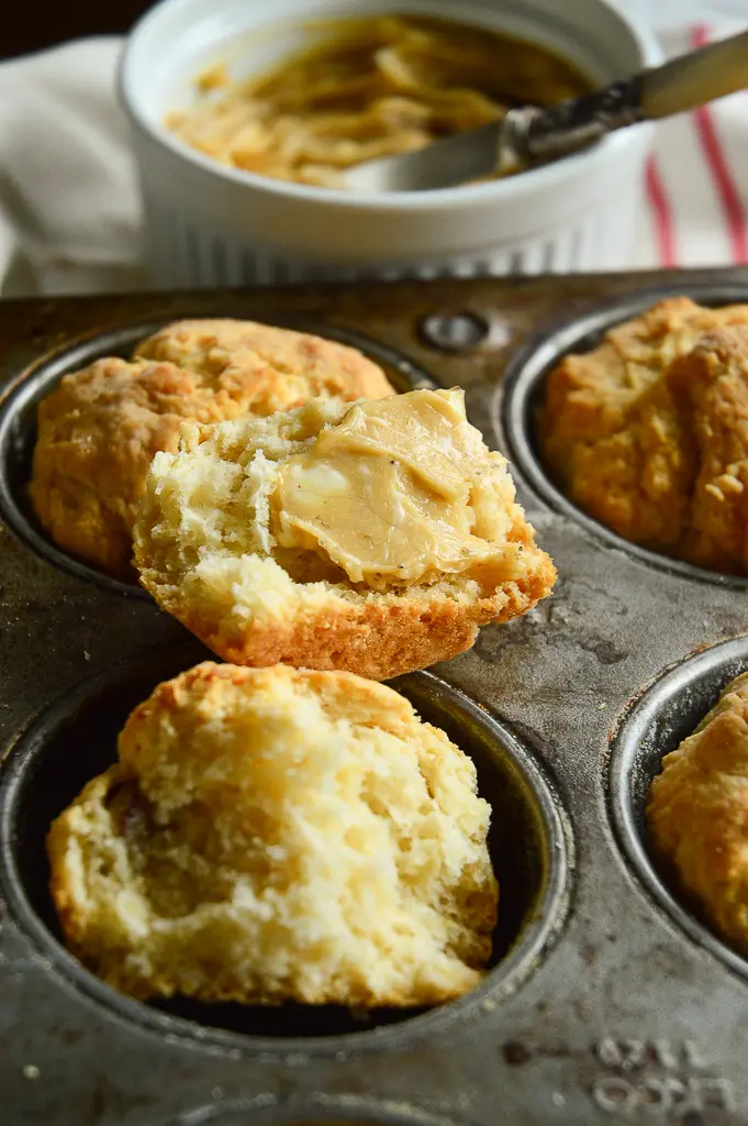 Homemade biscuit recipe in muffin pan with butter