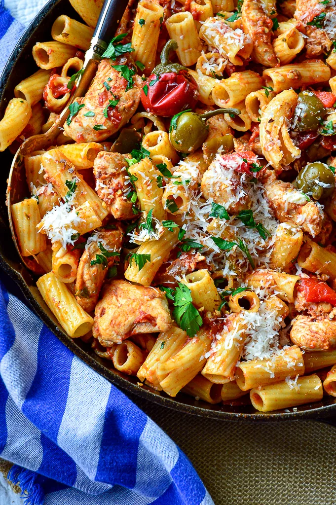 chicken riggies recipe in cast iron skillet with blue napkin