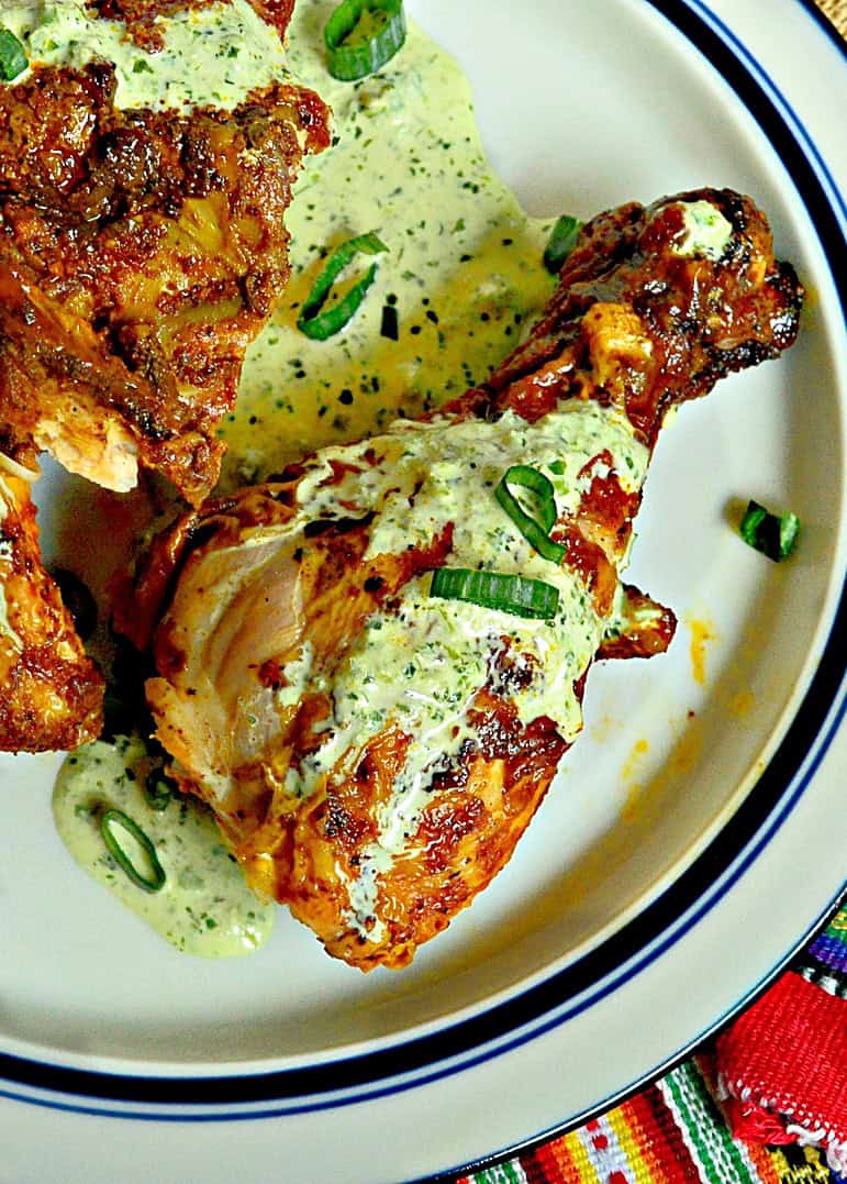 peruvian chicken with green sauce with blue banded plate