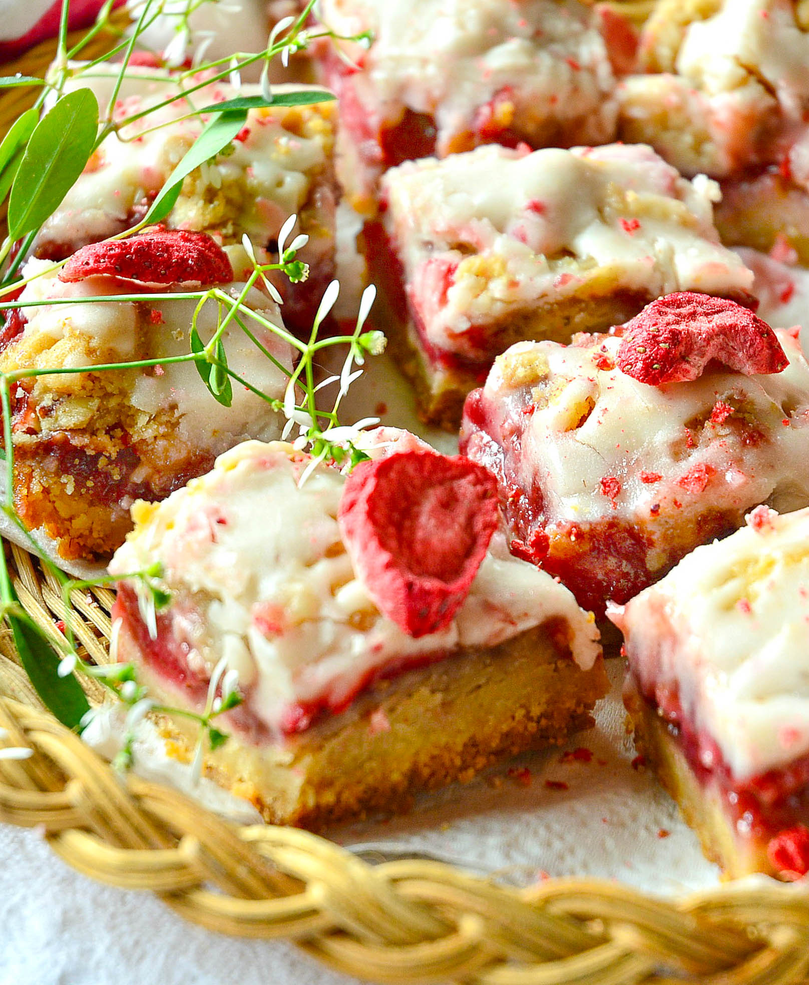 strawberry crumble bars on wicker plate