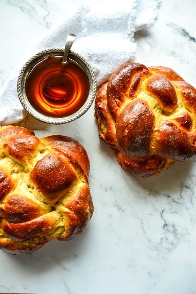 challah with apples and honey and a bowl of honey
