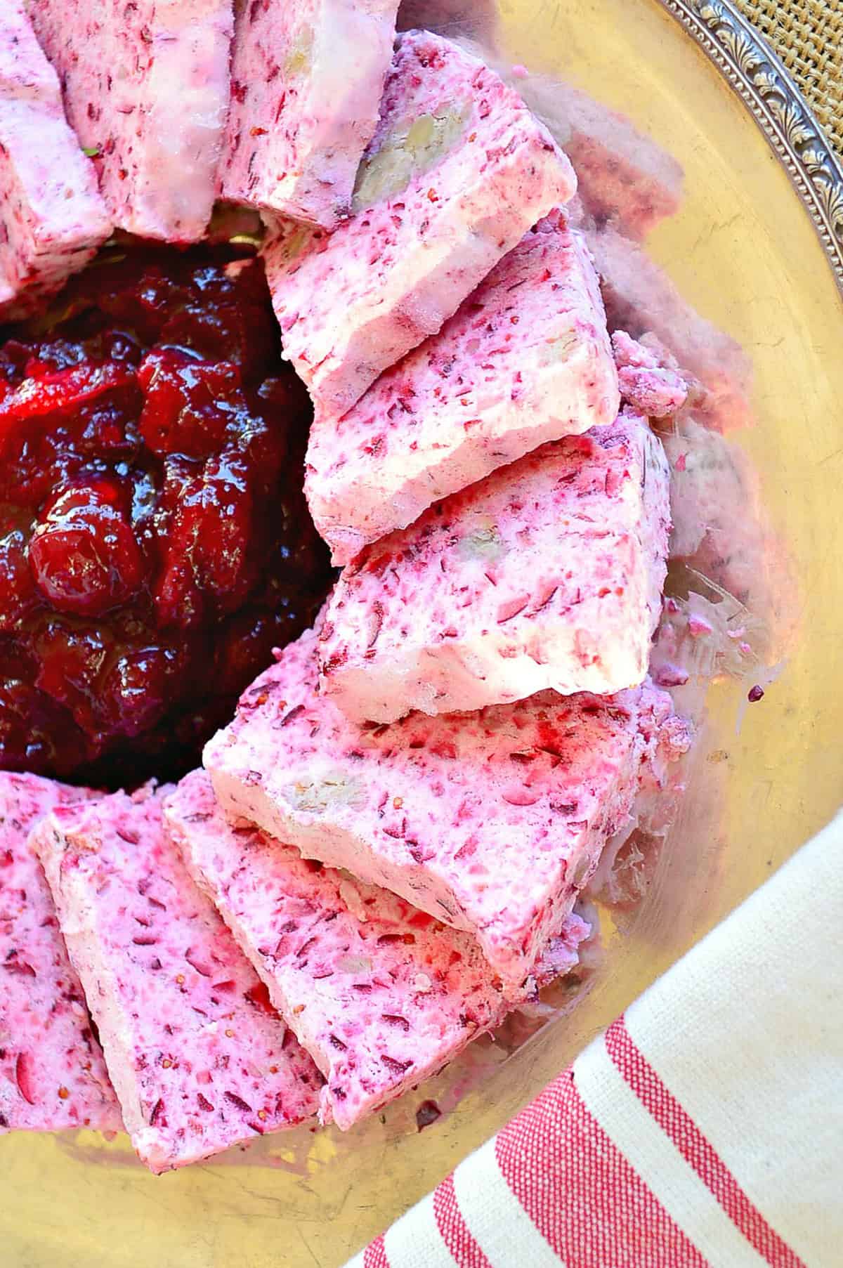 frozen cranberry salad with jelled cranberry relish on silver platter