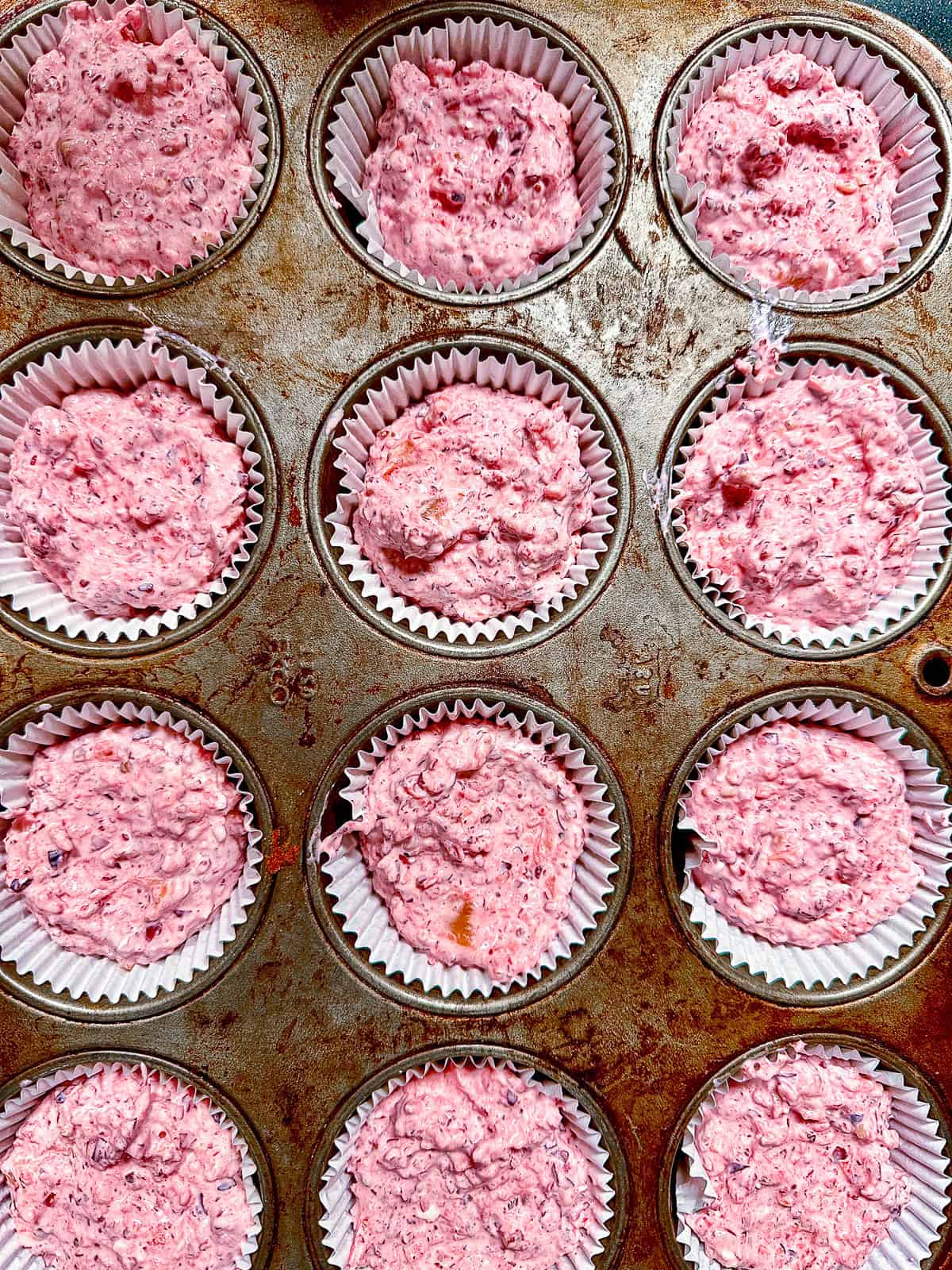 unfrozen cranberries in muffin tins