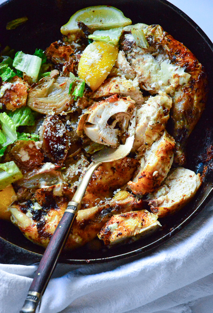 Caesar Roast Chicken in Cast Iron Skillet with Serving Spoon