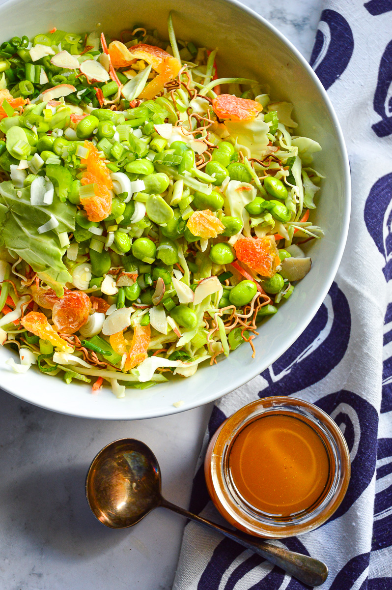 Asian Ramen Salad, dressing in jar, ladle, blue pattern napkin
