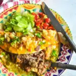 Mexican burger with fork on plate