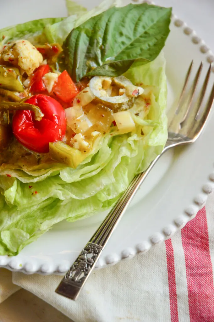 Iceberg lettuce salad round on plate with fork