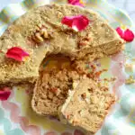 Jewish Apple cake with 2 slices and cake garnished with rose petals on platter